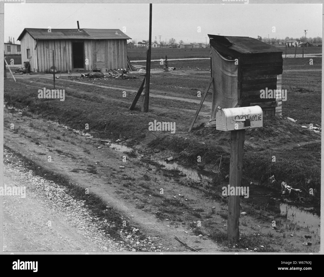 Olivehurst, Yuba County, California. Self-built house and privy. Note scarcity of windows and lack o . . .; Scope and content:  Full caption reads as follows: Olivehurst, Yuba County, California. Self-built house and privy. Note scarcity of windows and lack of glass. Stock Photo