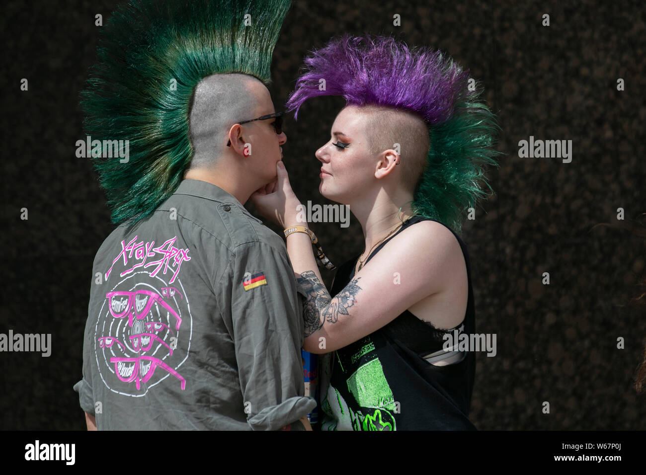 Two punks with Mohican haircut & liberty spikes in Blackpool, Lancashire, UK. 31st July, 2019.  Rebellion Festival world's largest punk festival in Blackpool. At the beginning of August, Blackpool’s Winter Gardens plays host to a massive line up of punk bands for the 21st edition of Rebellion Festival attracting thousands of tourists to the resort.  Over 4 days every August in Blackpool, the very best in Punk gather for this social event of the year with 4 days of music across 6 stages with masses of bands. Credit; MediaWorldImages/Alamy Live News Stock Photo