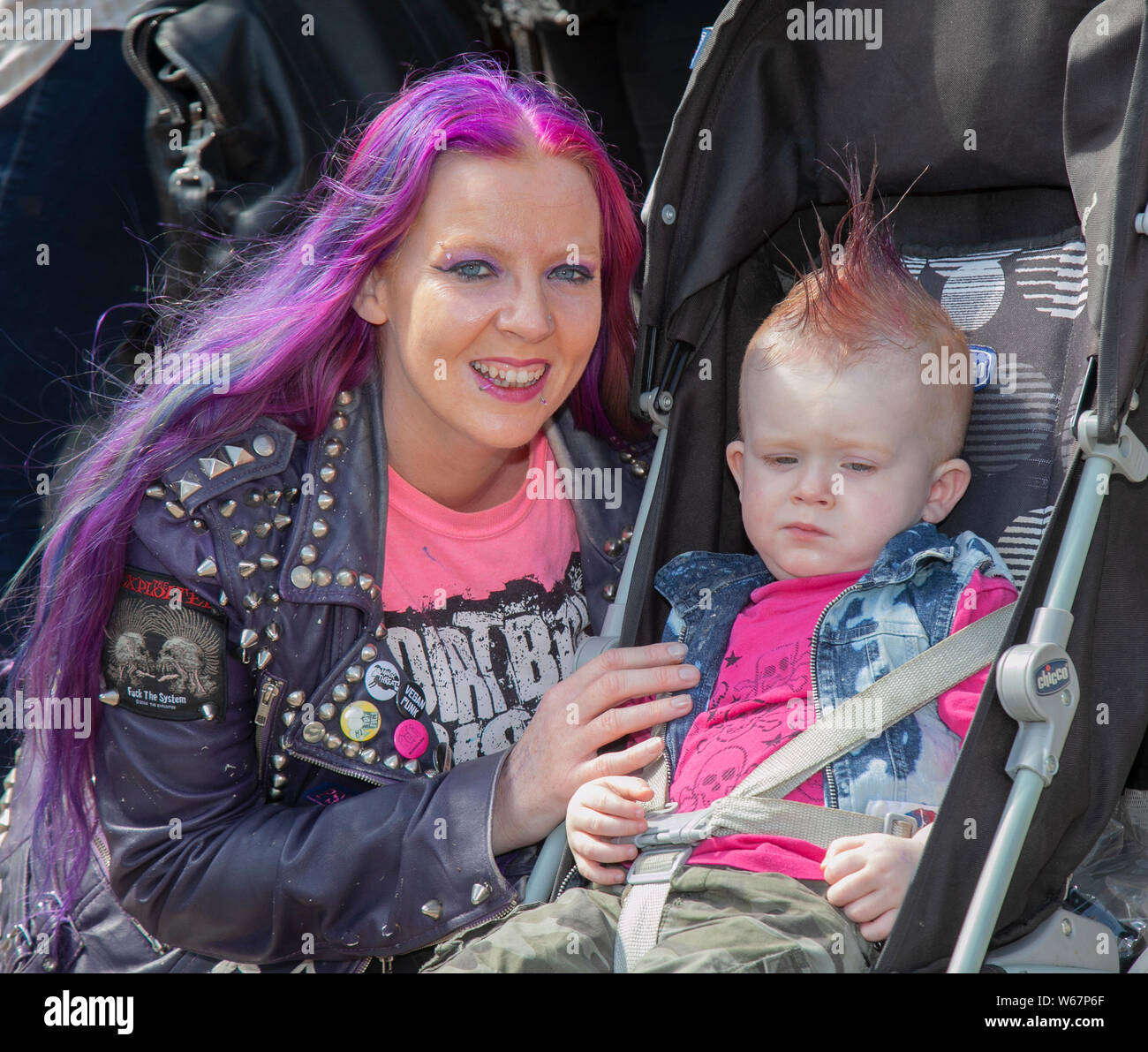Blackpool, Lancashire, UK. 31st July, 2019.  Kingsley Phoenix 2 years old and May Kiely at the Rebellion Festival the world's largest punk festival in Blackpool. At the beginning of August, Blackpool’s Winter Gardens plays host to a massive line up of punk bands for the 21st edition of Rebellion Festival attracting thousands of tourists to the resort.  Over 4 days every August in Blackpool, the very best in Punk gather for this social event of the year with 4 days of music across 6 stages with masses of bands. Credit; MediaWorldImages/Alamy Live News Stock Photo