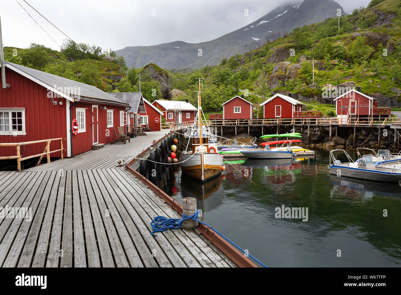 Fishermans cabins (Rorbuer) at a landing stage in the village Nusfjord, Lofoten islands, Norway Stock Photo