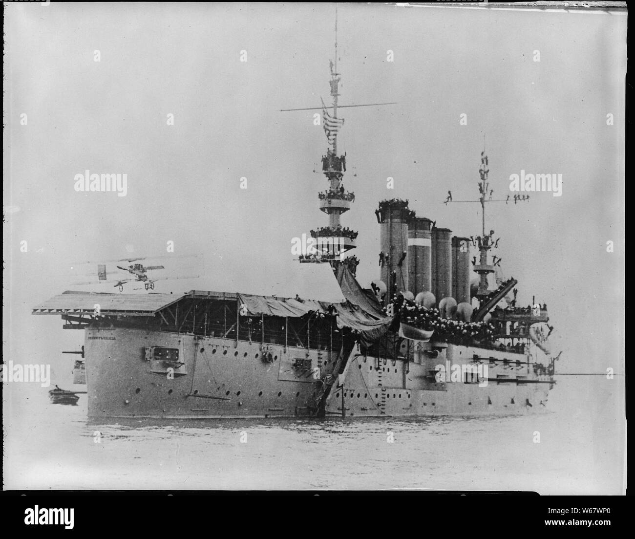 Pennsylvania (Armored Cruiser 4), starboard stern quarter with Eugene P. Ely landing plane on flight deck, 01/18/1911; Scope and content:  The Pennsylvania (Armored Cruiser 4), renamed the Pittsburgh in 1912. Starboard stern quarter with Eugene P. Ely landing plane on flight deck. Stock Photo