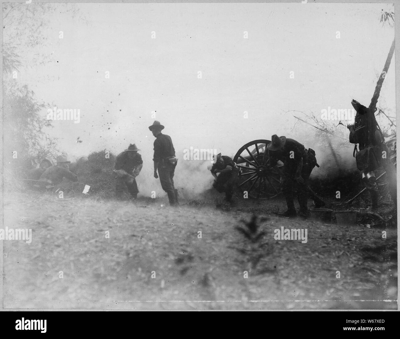 Photograph of Utah Battery on McCloud Hill  , 02/05/1899; Scope and content:  Original caption: Fire! Utah Battery on McCloud Hill, Sunday morning, February 5, 1899. This shot did great execution among the Insurgents on San Juan Bridge. A soldier was killed near this gun a few minutes after this shot. Greely Collection. General notes:  Use War and Conflict Number 314 when ordering a reproduction or requesting information about this image. Stock Photo