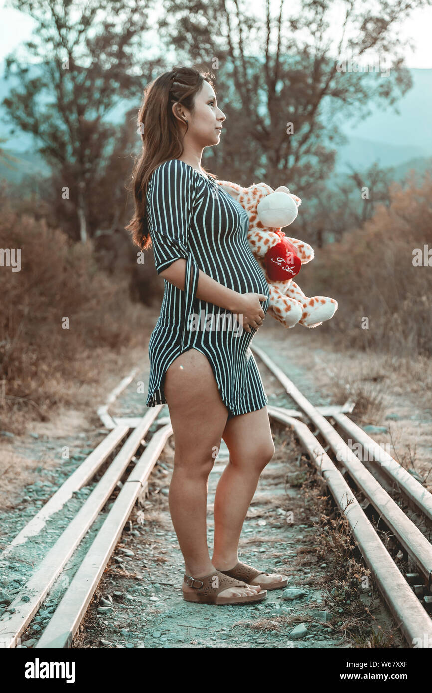 Pregnant woman in the woods Stock Photo