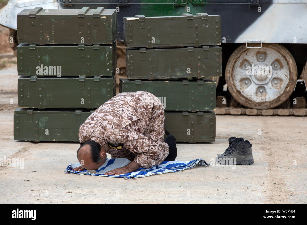 Iranian tankman is praying before start tank shooting during the international competition 'Tank biathlon-2019' at the military range 'Alabino', Russi Stock Photo