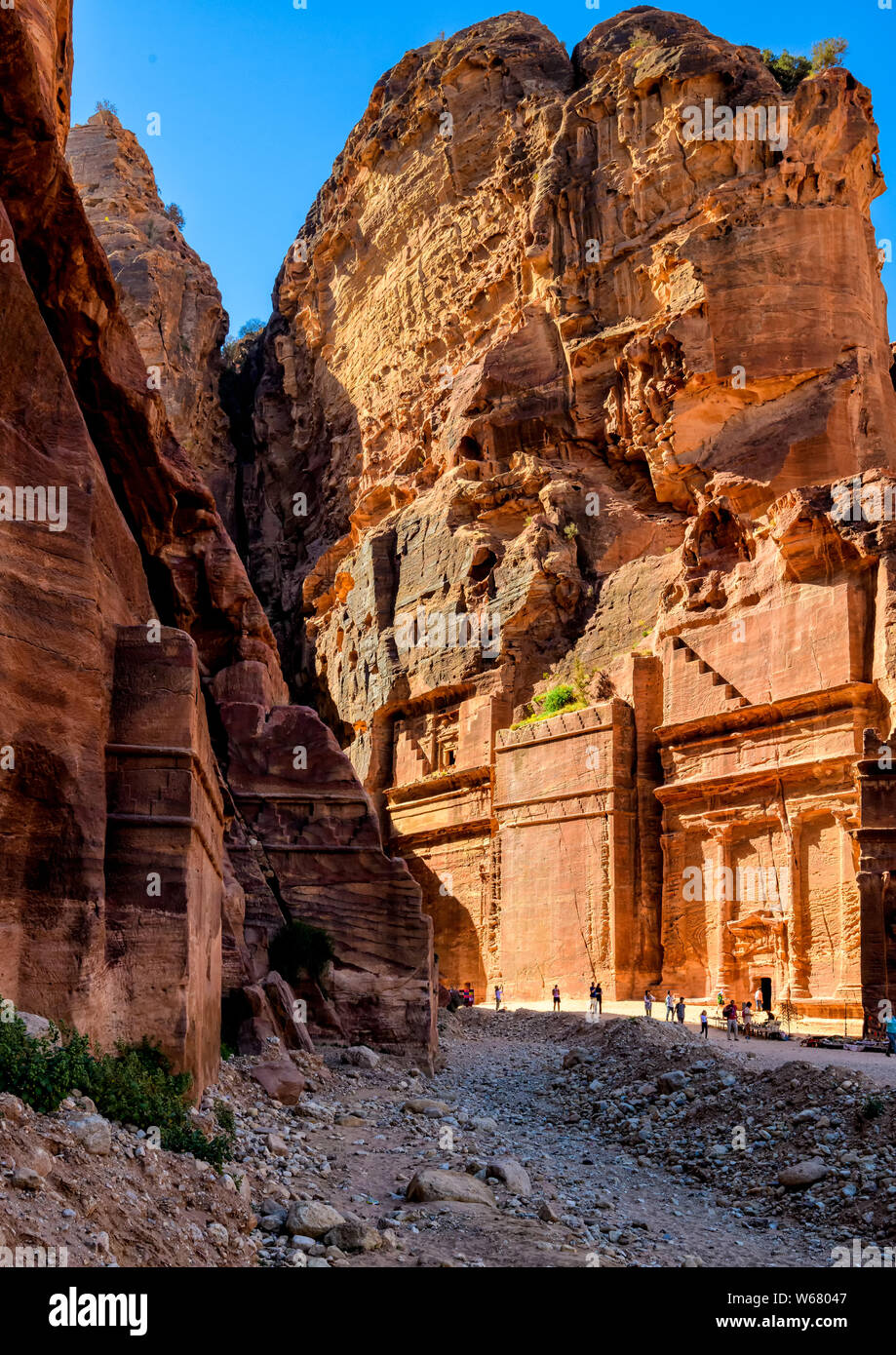 Some of the many tombs lining the red sandstone cliffs along the area known as the street of facades Stock Photo