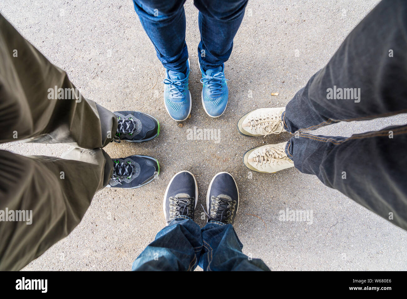 Group of four persons standing together in a circle as a team Stock Photo