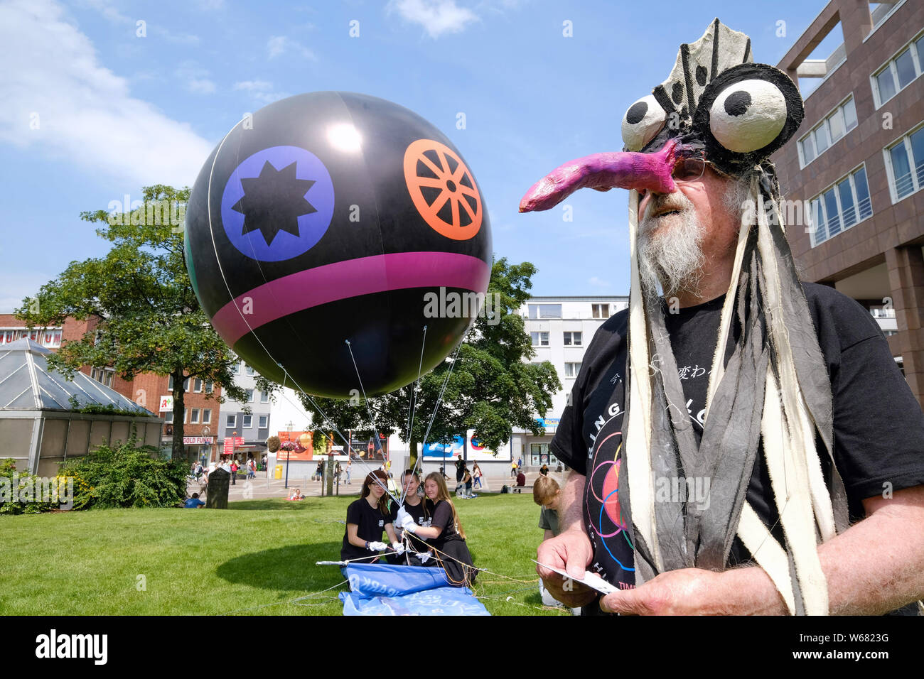 Dortmund / Germany, 22.June 2019. The Dortmund artist LEO LEBENDIG demonstrates with a balloon, on which the symbols of the world religions are painted, for a peaceful coexistence of the religions Stock Photo