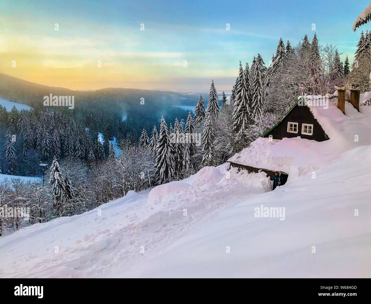 Czech mountains Krkonose landscape in winter in the early morning with lovely small wooden cottage Stock Photo