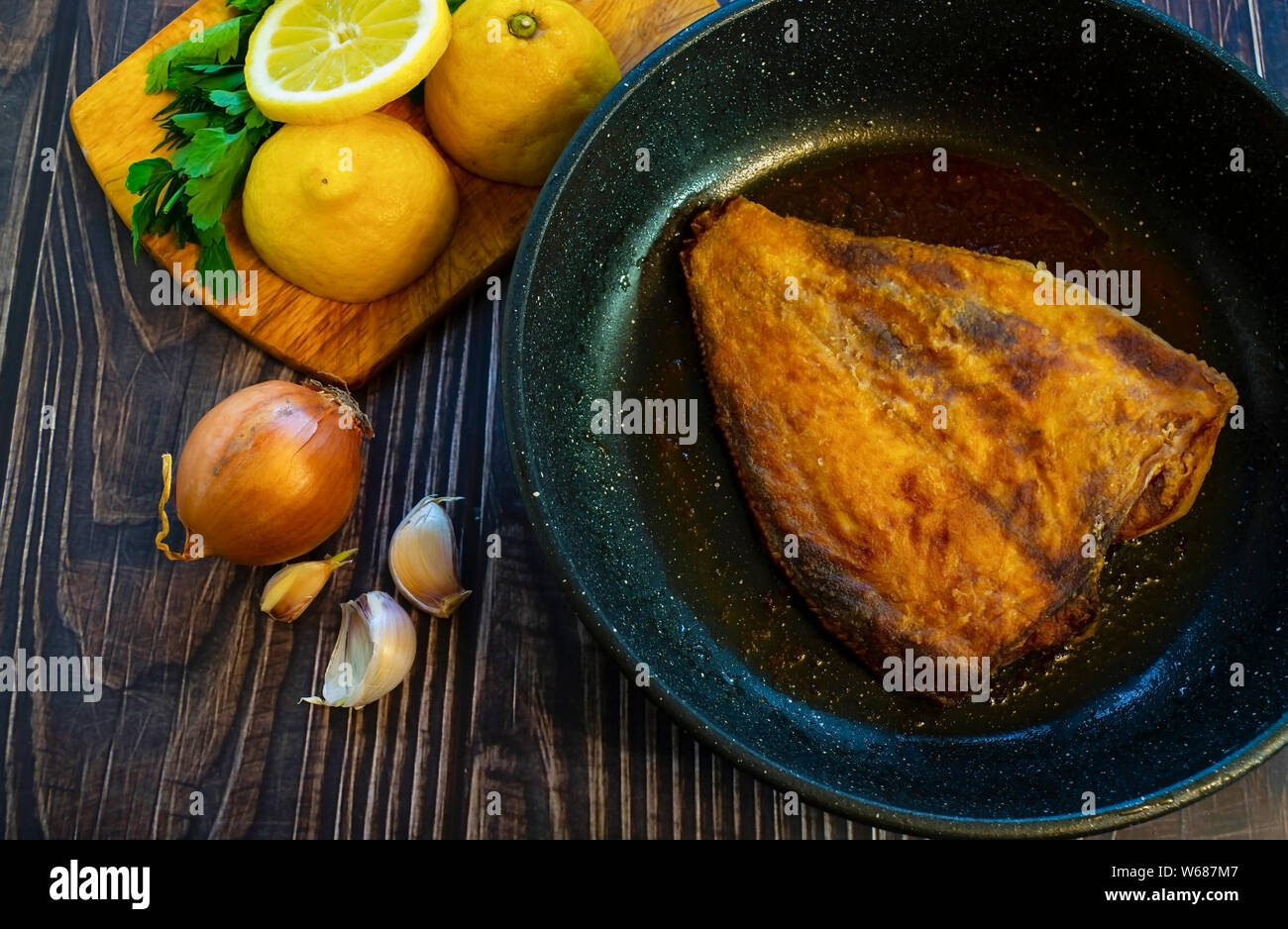 Fried flounder in a pan. Home cooking in a rustic style Stock Photo Alamy