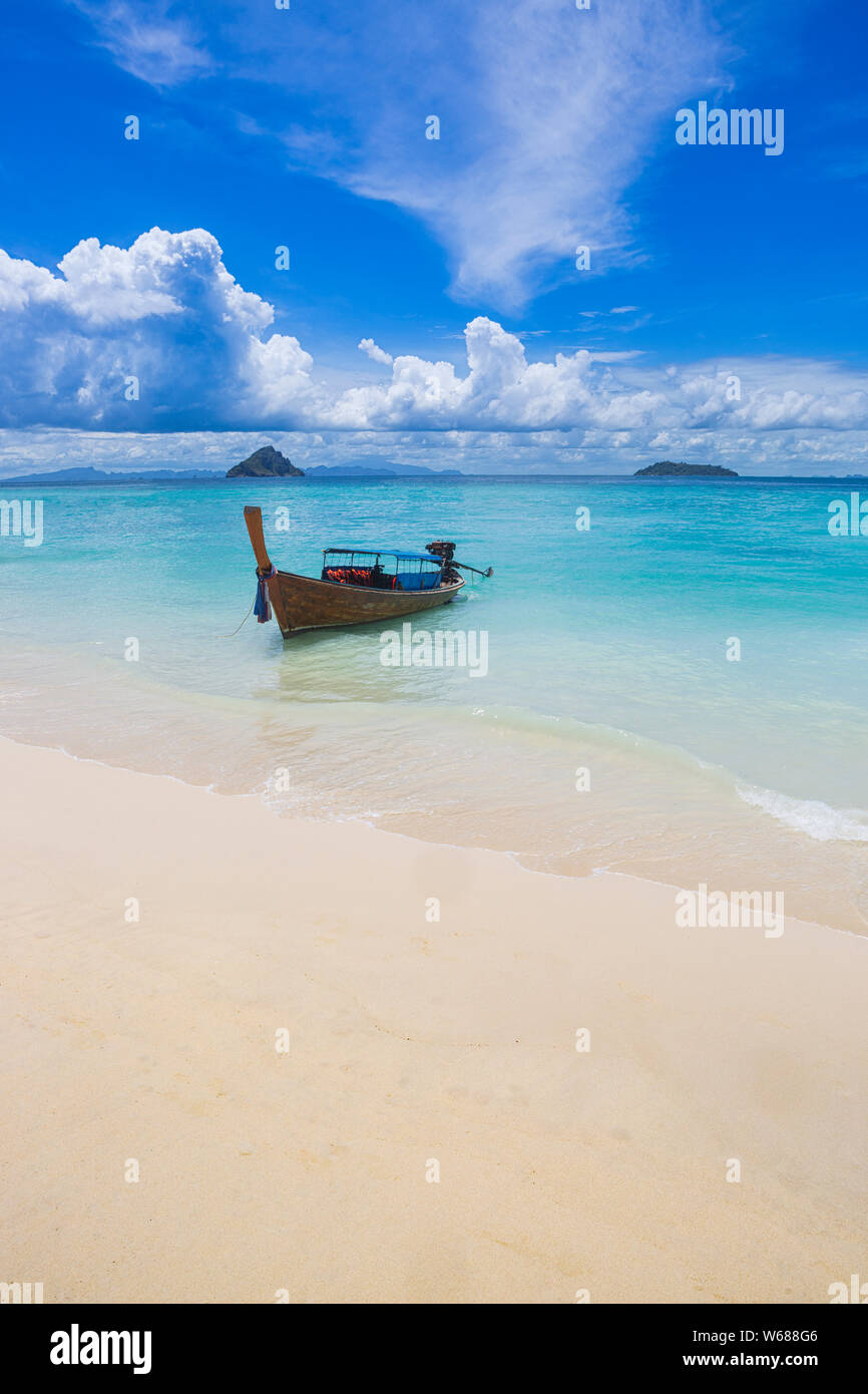 Longtail Boat at the Laemtong Beach on Phiphi island, Thailand. In the background Mosquito and Bamboo island. Stock Photo