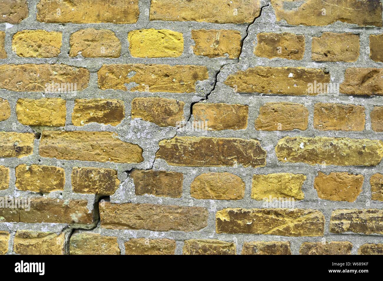 Yellow brick walls with old and weathered stones and cracks im high resolution Stock Photo Alamy
