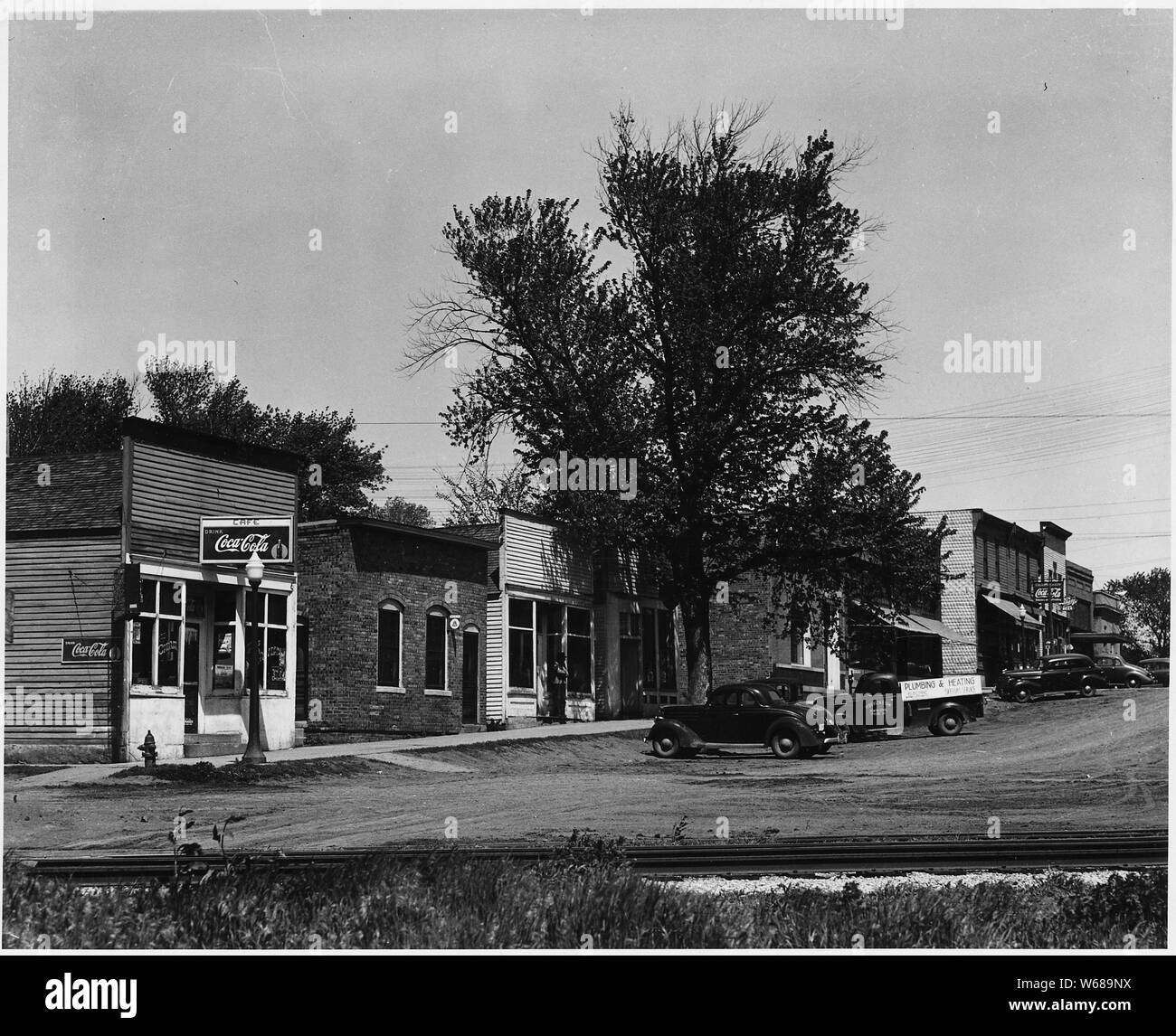 Shelby County, Iowa. The village of Irwin is the center of a community -- village and hinterland -- . . .; Scope and content:  Full caption reads as follows: Shelby County, Iowa. The village of Irwin is the center of a community -- village and hinterland -- including most of four townships. Its population, including both farm and village people, is about 1500. These pictures show Irwin's main street with its bank, post office, stores and offices. Farm people can buy most of what they need here in the village, but there are other and larger towns within easy driving distance whose stores are fa Stock Photo