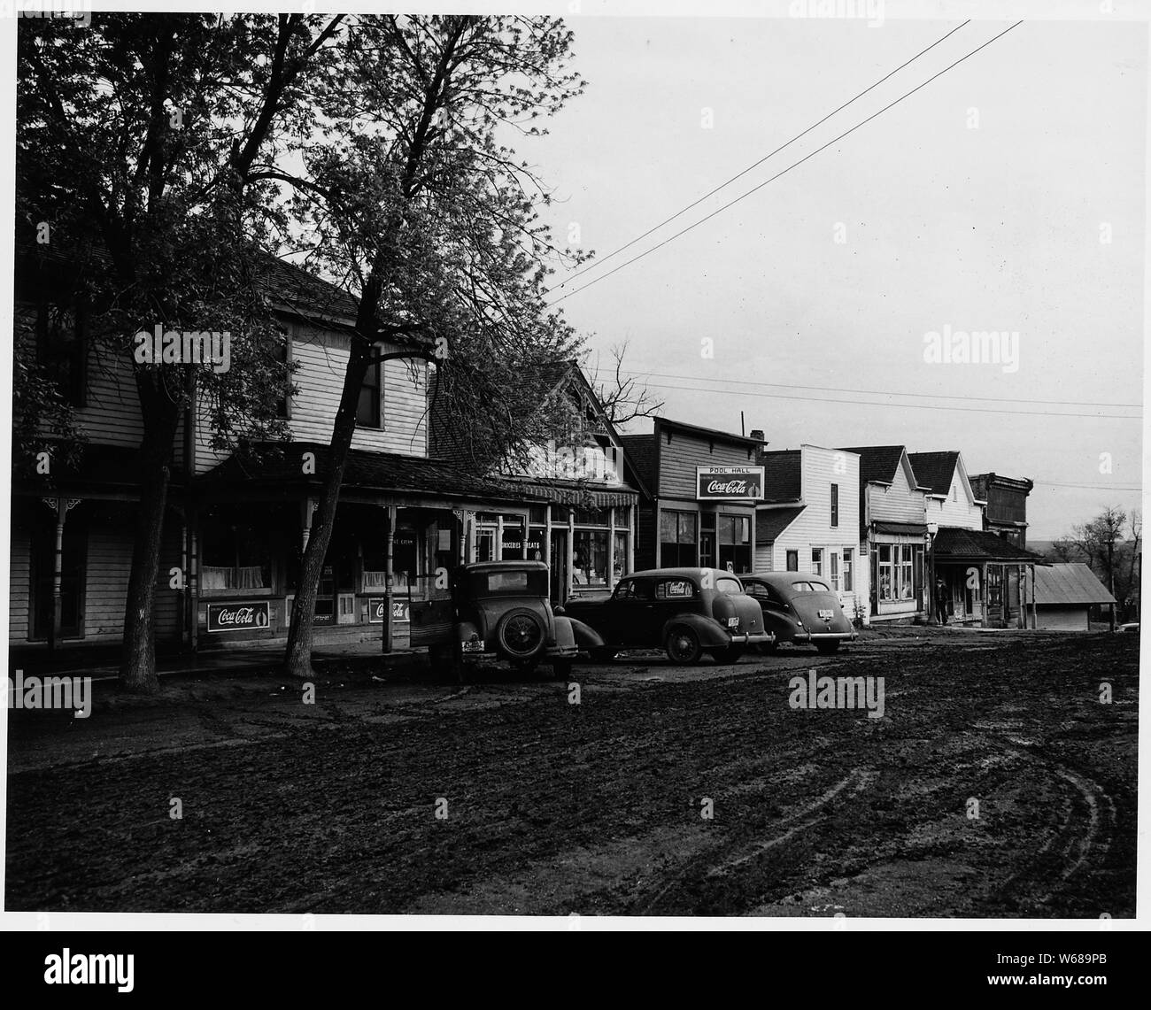 Shelby County, Iowa. The village of Irwin is the center of a community -- village and hinterland -- . . .; Scope and content:  Full caption reads as follows: Shelby County, Iowa. The village of Irwin is the center of a community -- village and hinterland -- including most of four townships. Its population, including both farm and village people, is about 1500. These pictures show Irwin's main street with its bank, post office, stores and offices. Farm people can buy most of what they need here in the village, but there are other and larger towns within easy driving distance whose stores are fa Stock Photo