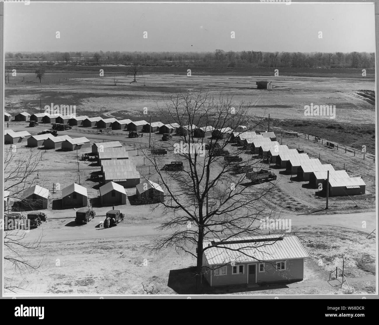 Sutter County, near Yuba City, California. View of camp for seasonal workers in Yuba City Farm Worke . . .; Scope and content:  Full caption reads as follows: Sutter County, near Yuba City, California. View of camp for seasonal workers in Yuba City Farm Workers Community (F.S.A.). Note steel shelters, a type of housing which replaces the use of tents in the newer camps. Note clinic of Agricultural Workers Health and Medical Association (F.S.A.). Stock Photo