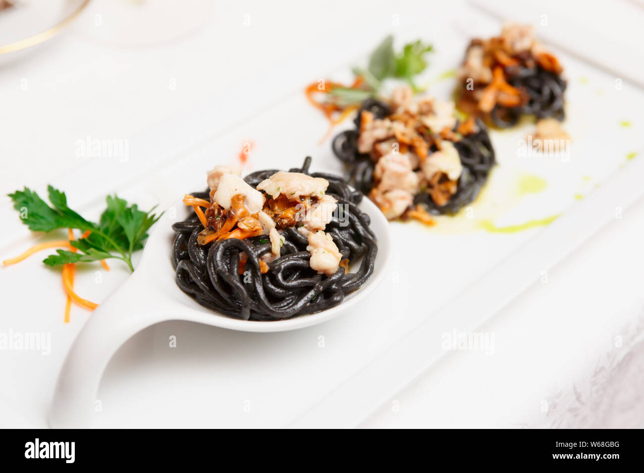 Black pasta with seafood, gourmet dish, close-up Stock Photo - Alamy