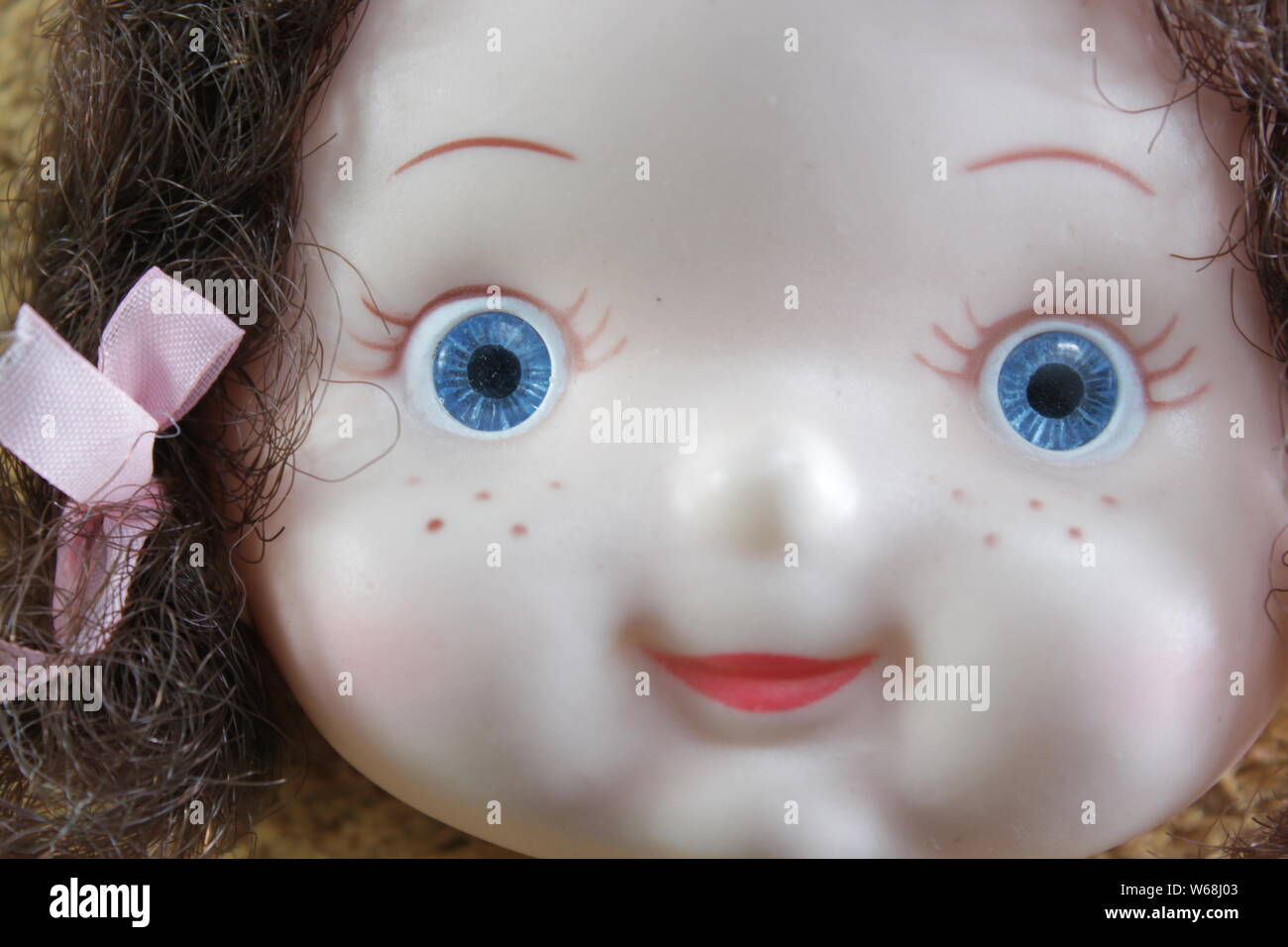 Plastic face of a blue eyed doll Stock Photo Alamy