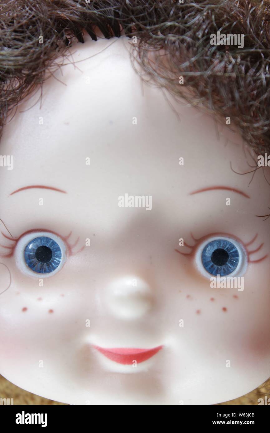 Plastic face of a blue eyed doll Stock Photo Alamy