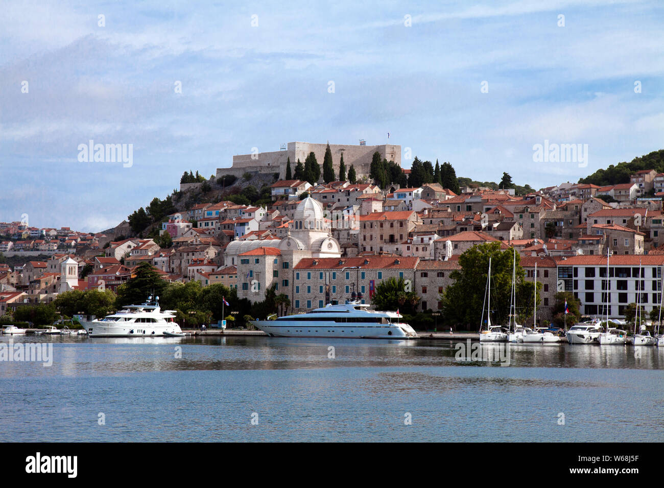 Sibenik, Croatia as seen from harbor approach. St. Michael's Fortress dominates the skyline, thought to date to the late 8th or early 9th century. Stock Photo