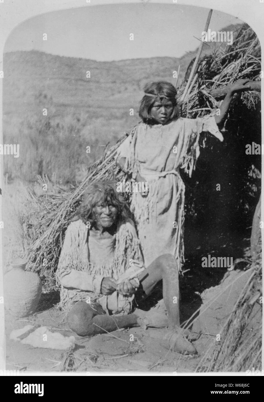 The Arrow Maker and his daughter, Kaivavit Paiutes, in front of their home, northern Arizona, 10/04/1872 Stock Photo