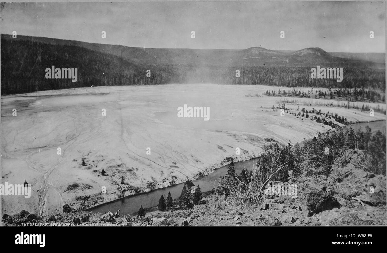 The Great Hot Springs, upper end of the lower basin. Yellowstone National Park.; An overlook showing pretty much the entire Midway Geyser Basin.  Grand Prismatic Spring is on the left of the image; the crater of Excelsior Geyser is in the center. Stock Photo