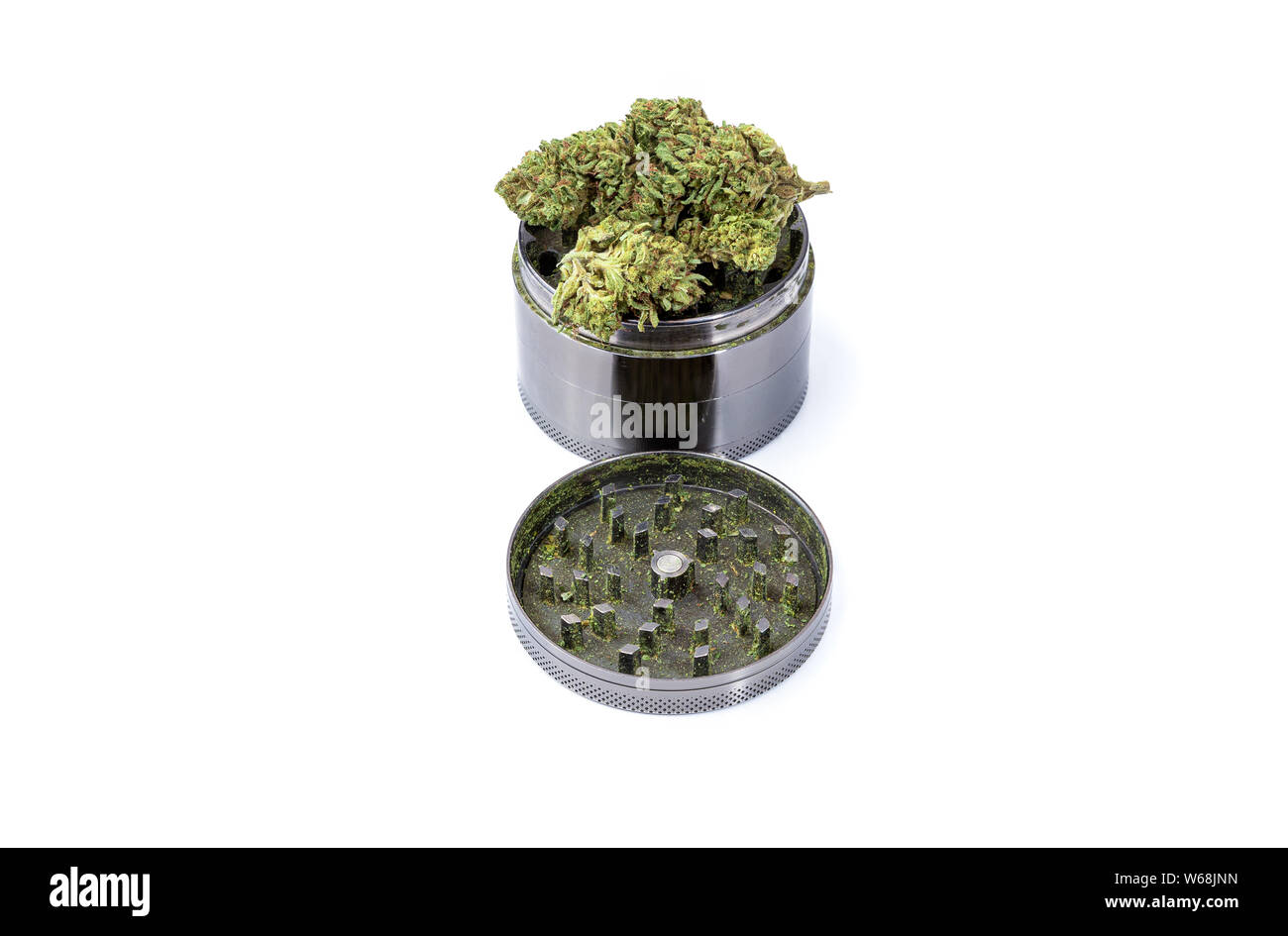 Close up, detailed photo of medical marijuana buds on top of a steel grinder against a white background Stock Photo
