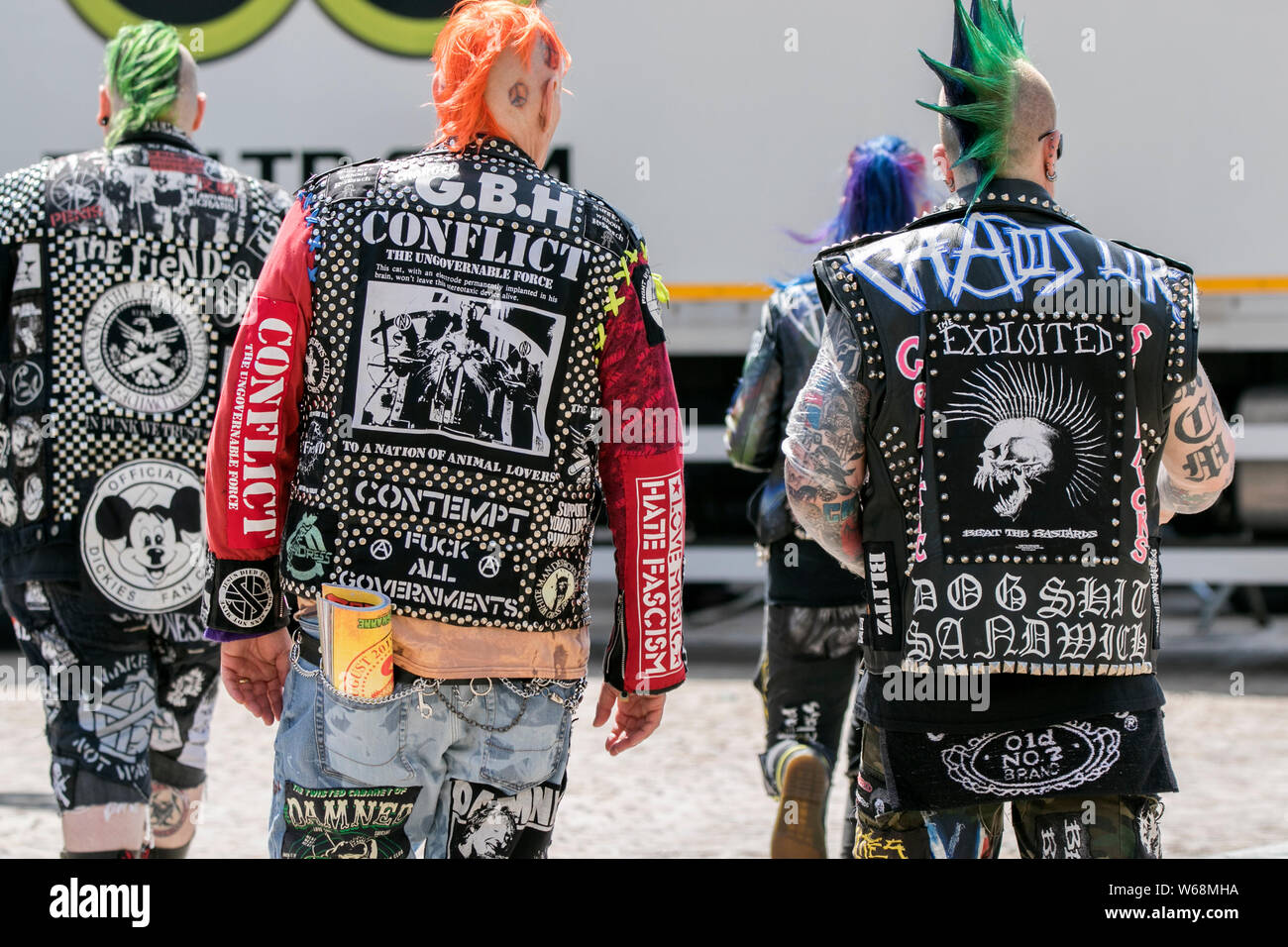Studded illustrated jackets, dyed hair and punks in Blackpool, Lancashire, UK. July 2019. The fabulous Punk Rebellion festival returns to the Winter Gardens in Blackpool for a weekend of live punk rock music.  The Rebellion Festival, formerly Holidays in the Sun and the Wasted Festival is a British punk rock festival first held in 1996.  This open to all event draws thousands of overseas visitors to see all their favourite punk musicians in one place. Credit: Cernan Elias/Alamy Live News Stock Photo