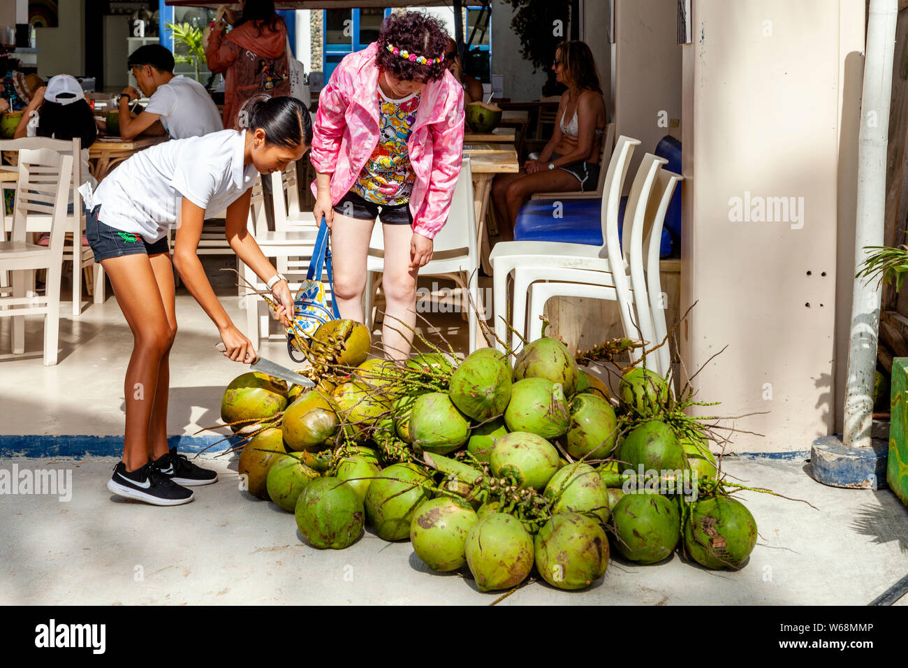 buko juice high resolution stock photography and images alamy https www alamy com a filipino cafe worker selects coconuts to make buko juice a coconut water drink white beach boracay aklan province the philippines image262035334 html