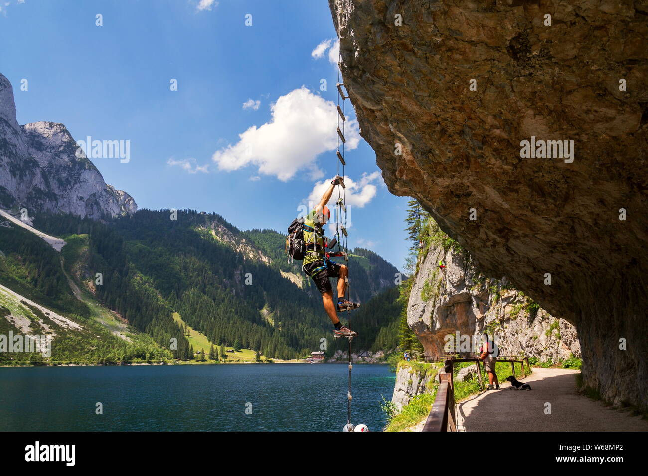 GOSAU, AUSTRIA - JULY 4 2019: Man climbing on Laserer alpin via ferrata  over Vorderer Gosausee lake with Grosser Donnerkogel Mountain in background  Stock Photo - Alamy