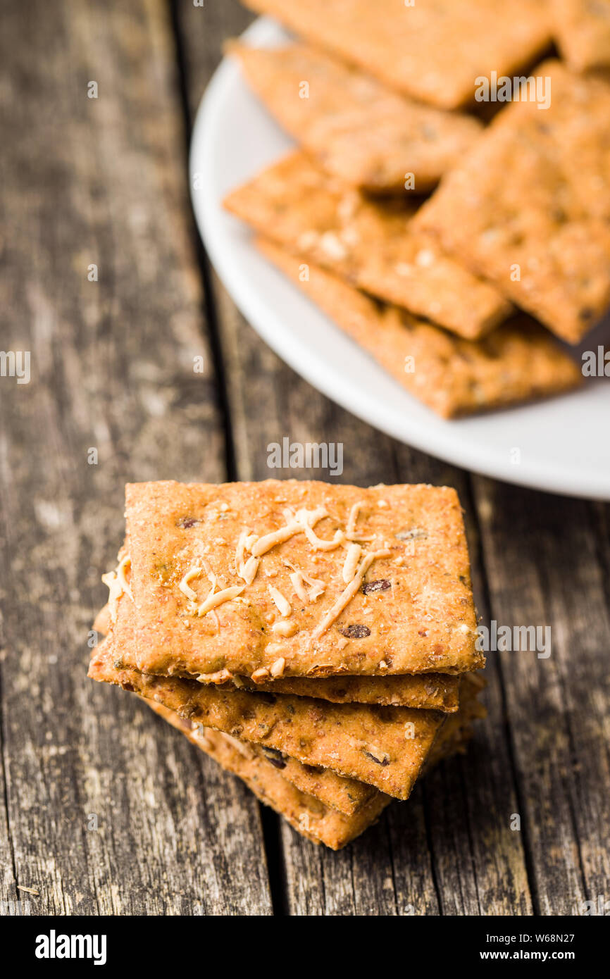 Salted crispy crackers on wooden table. Stock Photo