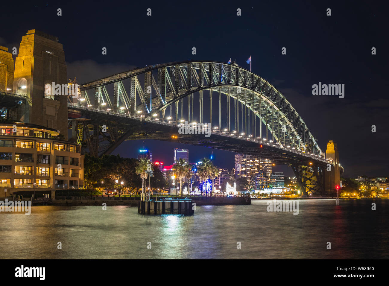 The Sydney Harbour Bridge is a heritage-listed steel through arch bridge across Sydney Harbour that carries rail, vehicular, bicycle, and pedestrian. Stock Photo