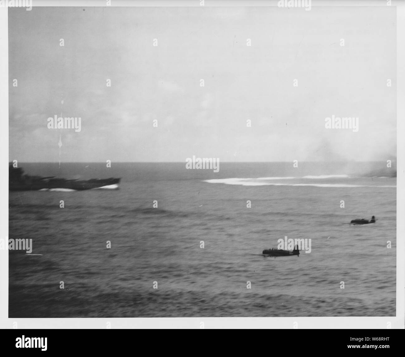 SOUTH DAKOTA UNDER ATTACK -- Two Japanese torpedo planes skim over the water towards the USS SOUTH DAKOTA during the Battle of Santa Cruz, October 26, 1942.  The SOUTH DAKOTA brought down 32 Japanese planes with her anti-aircraft guns in this battle.; English: Two Japanese Nakajima B5N2 Kate torpedo bombers near the USS South Dakota during the Battle of Santa Cruz in 1942.日本語: 「エンタープライズ」を雷撃すべく「サウスダコタ」の右舷をかすめる「瑞鶴」第二次攻撃隊の九七式三号艦上攻撃機。 Box: 19LCM, BB-57, BN204; Folder N  19LCM-BB57-2 ; File No: W-SPA-14-14084 Stock Photo