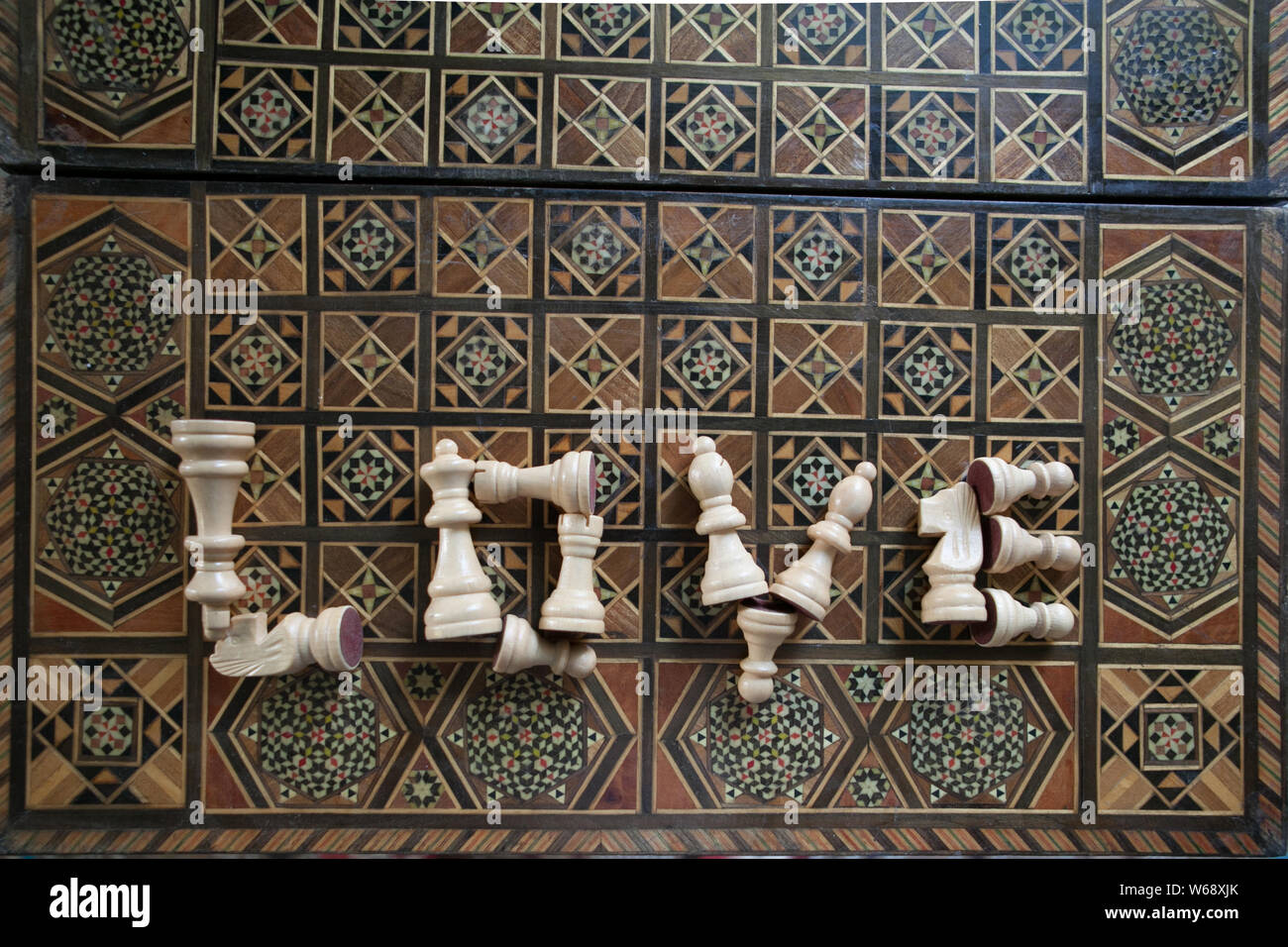 Top view of a word Love from chess pieces on an inlaid chessboard, selective focus Stock Photo