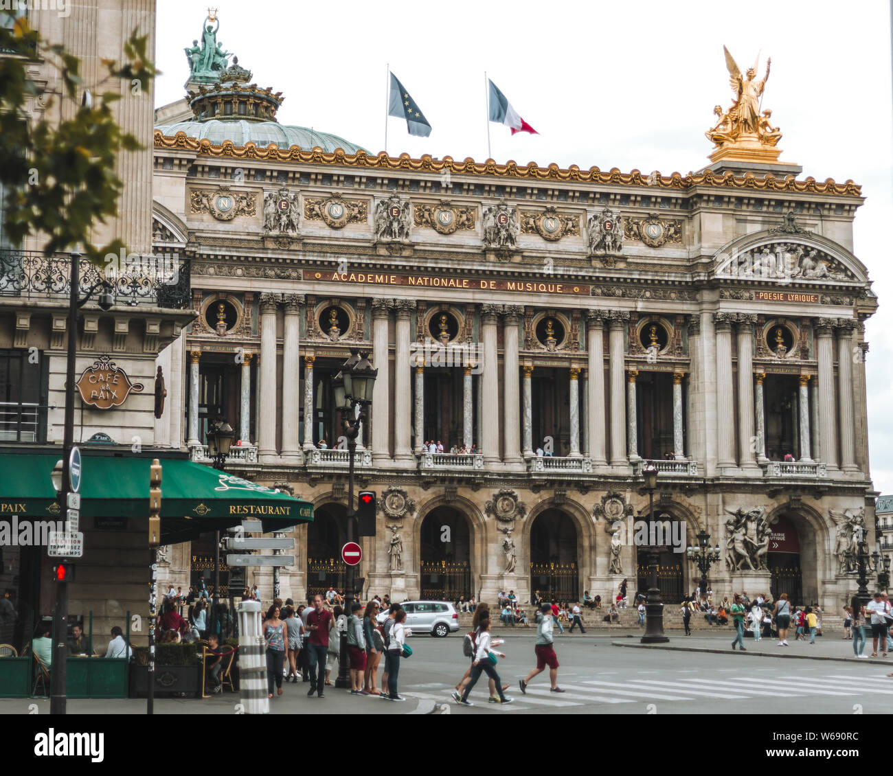 Paris, France-JULY 19, 2014: View on the Opera National de Paris and street with cafe. Grand Opera (Opera Garnier) is famous neo-baroque building in P Stock Photo