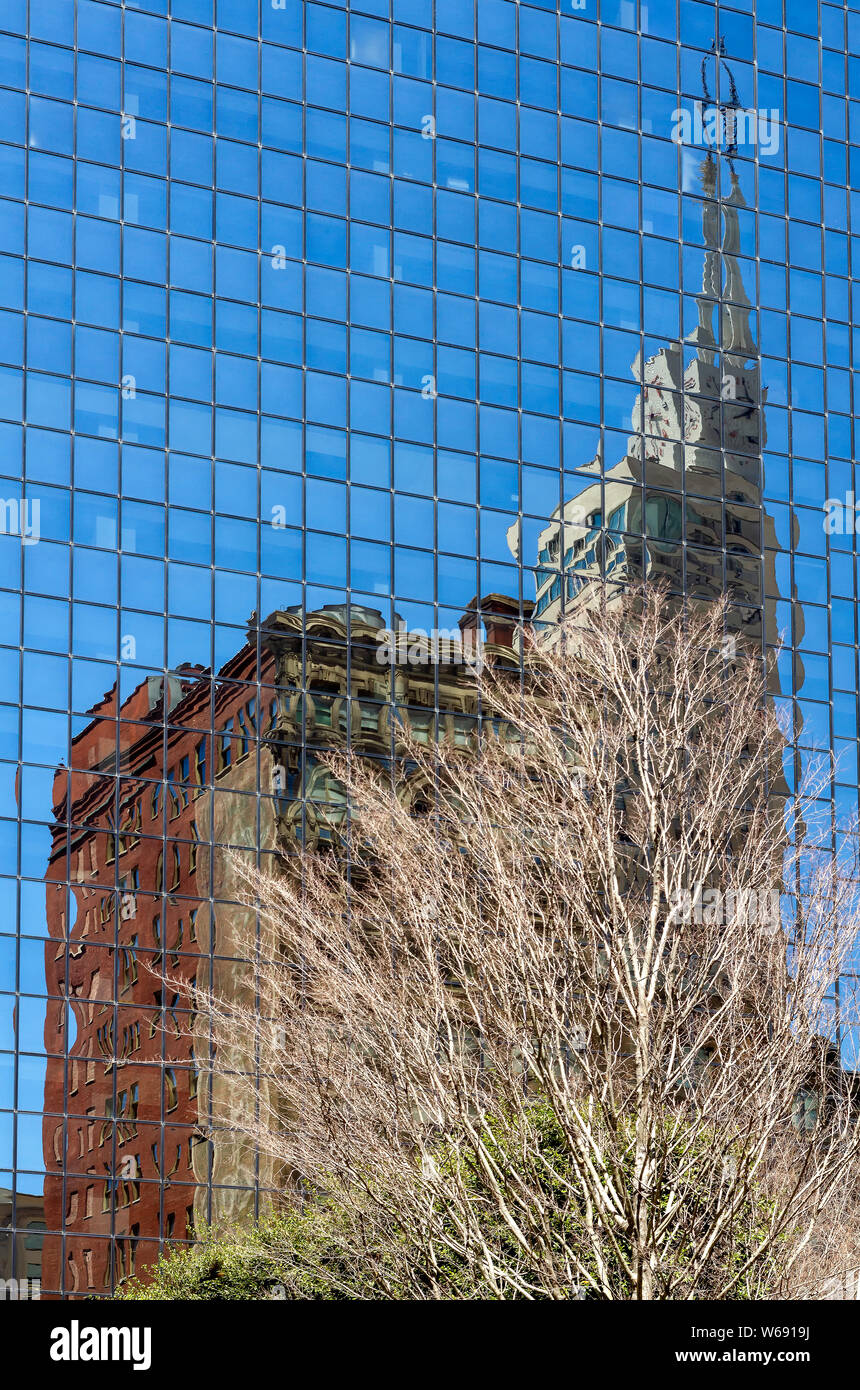 View of a modern glass skyscraper reflecting the old buildings around, Dallas, Texas, USA. Stock Photo