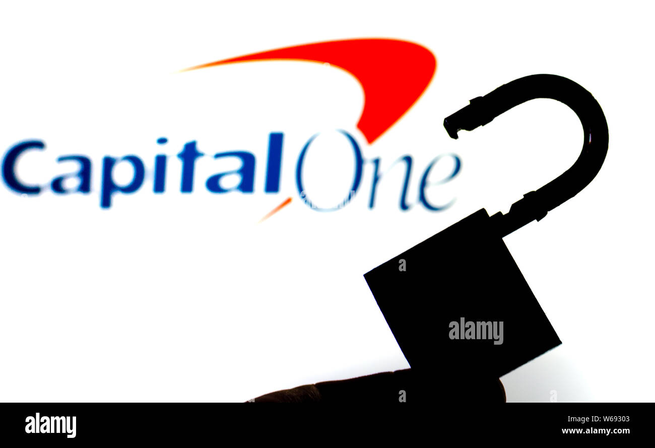 Capital One Bank logo on the background screen and a silhouette of the opened lock in front. Conceptual photo for news about the data breach. Stock Photo
