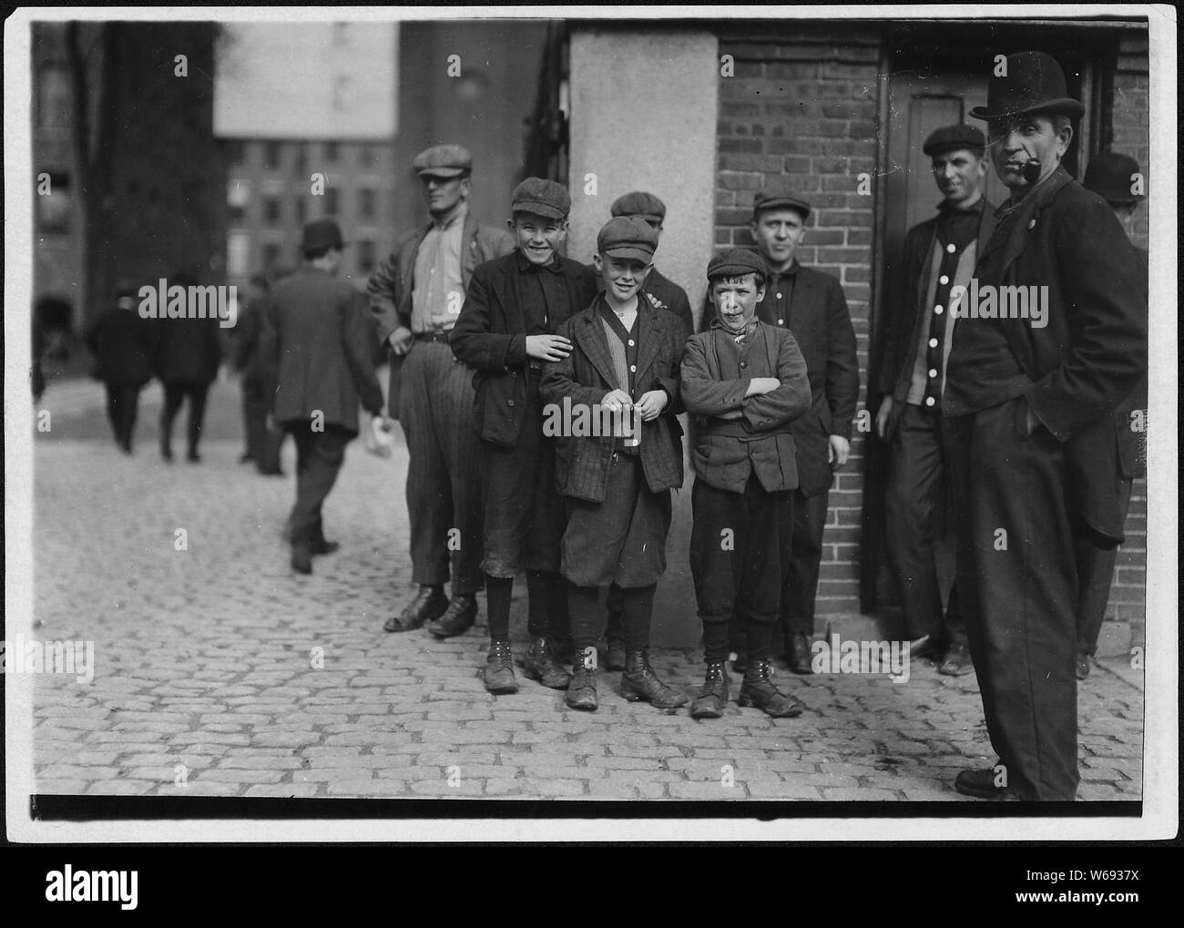 Workers in Merrimac Mill. Robert, smallest, 12 years old. Michael Keefe, next in size, about 13 or 14 years old. Cornelius Hurley, about 13 or 14. S. Framingham, Mass. Stock Photo
