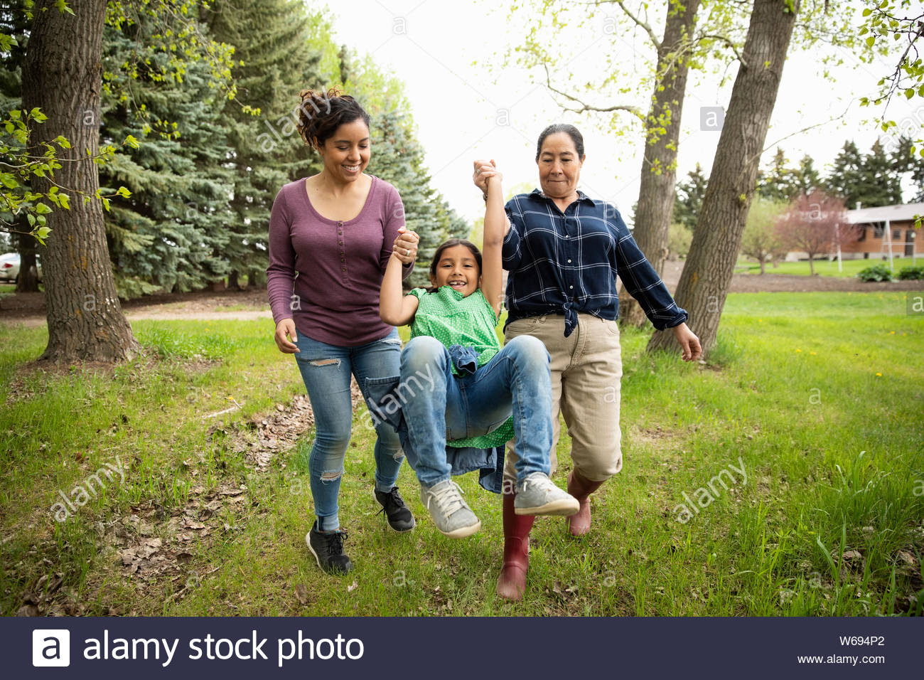 Playful multi-generation women in backyard Stock Photo