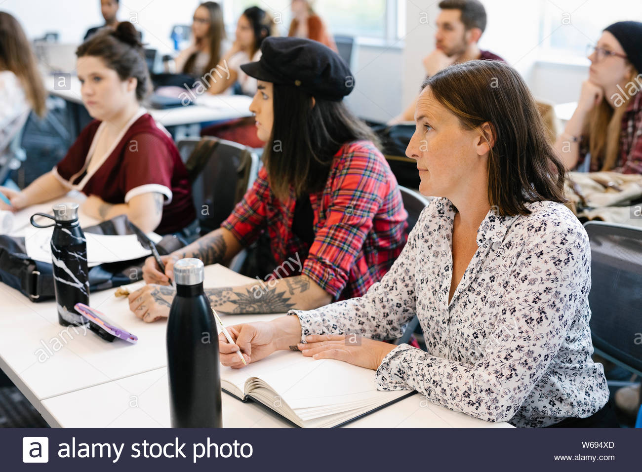 Mixed age students sitting and listening in university lecture Stock Photo