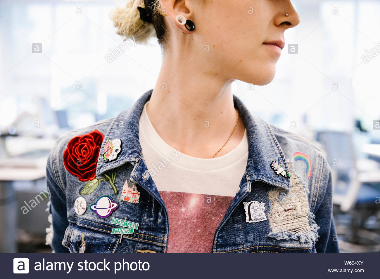 Student wearing denim jacket with badges close up Stock Photo