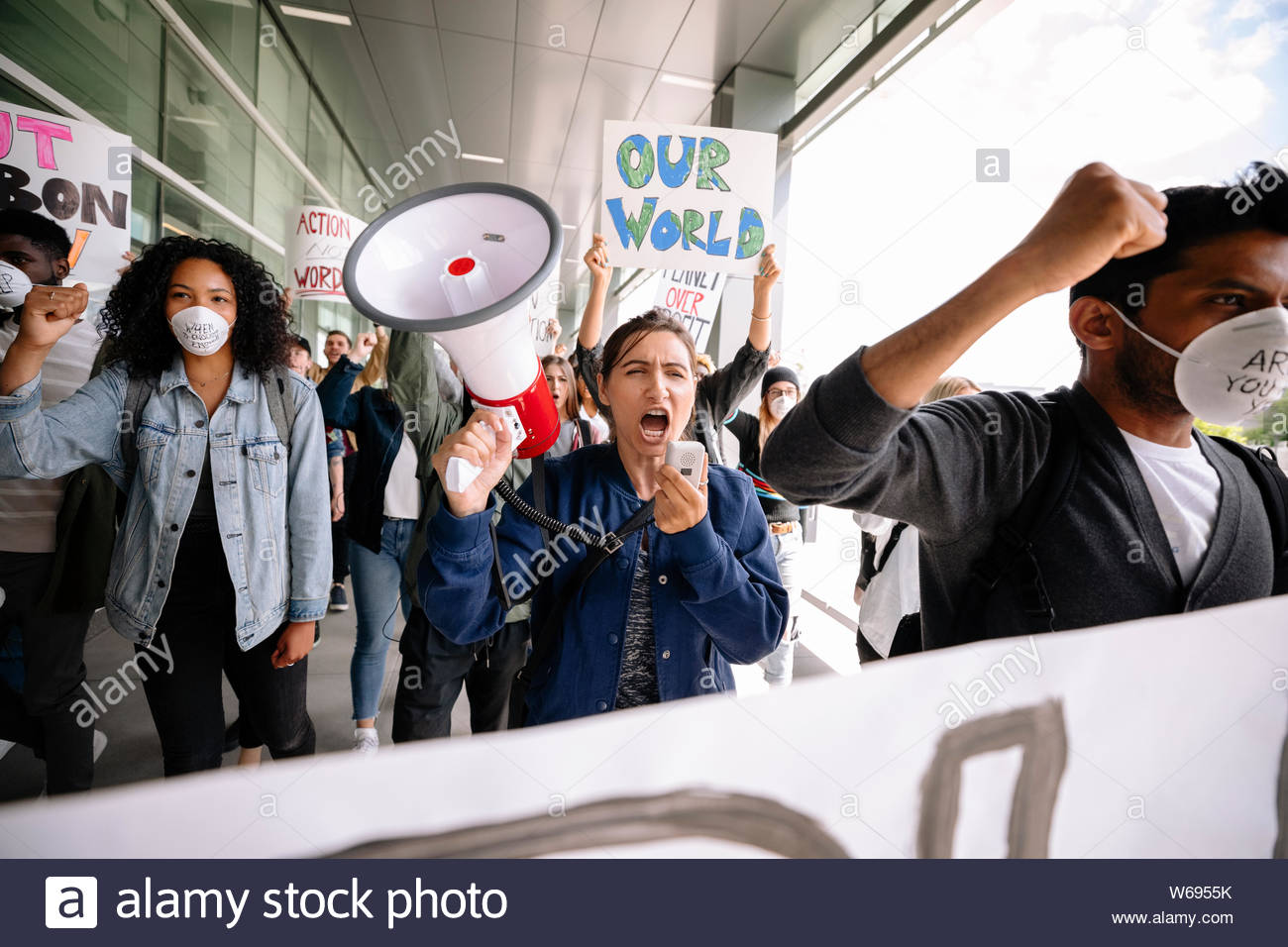 Multiracial students with megaphone protesting against climate change Stock Photo