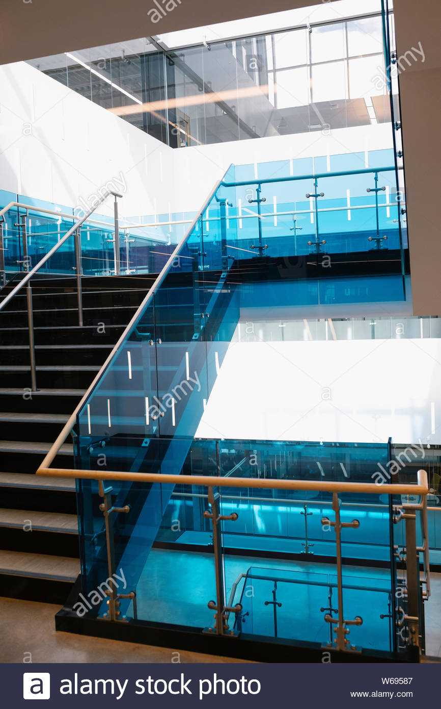 Staircase and glass balustrade in modern library interior Stock Photo
