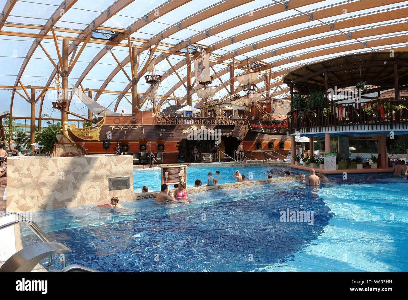 Liptovsky Mikulas, Slovakia - May 04, 2014: Blue big swimming pool and a pirate ship in the aquapark in Liptovsky Mikulas, Slovakia. Stock Photo