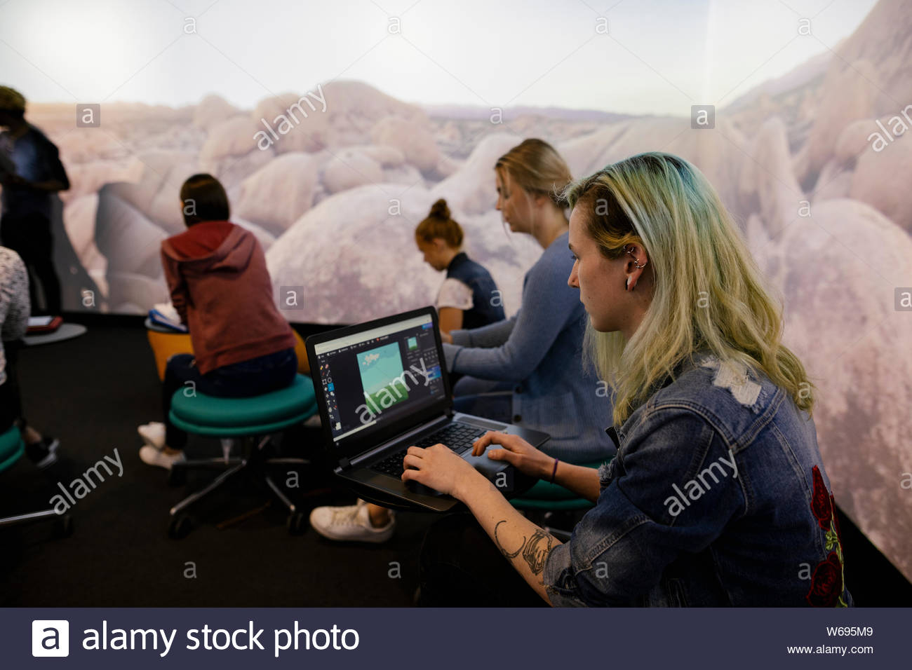 Student using laptop in VR classoom Stock Photo