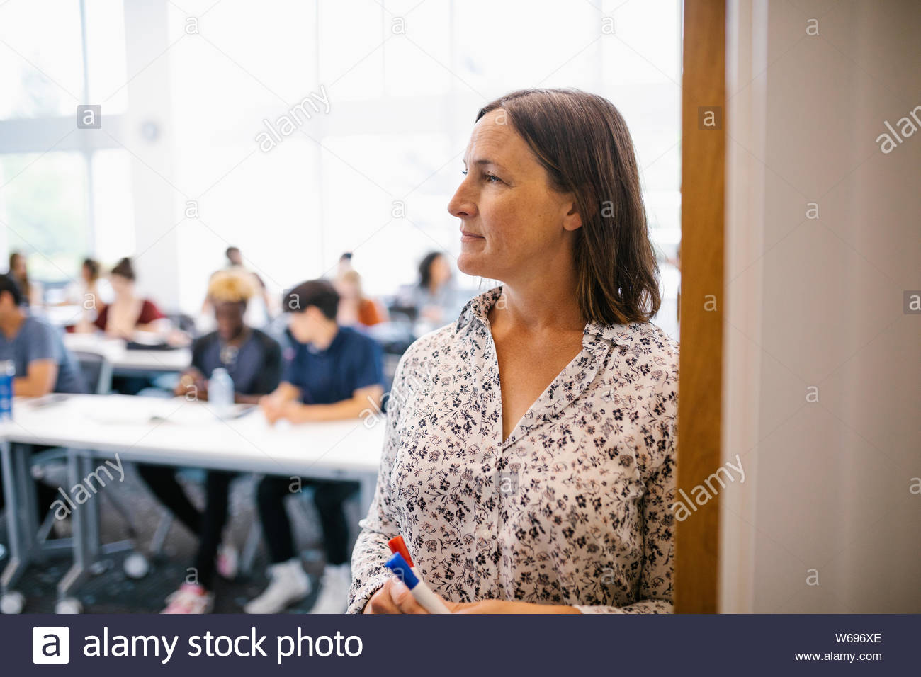 portrait-of-female-lecturer-looking-away-in-classroom-stock-photo-alamy