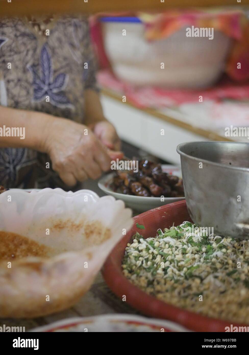 Seller preparing goat satay in traditional store at Kediri, Indonesia Stock Photo