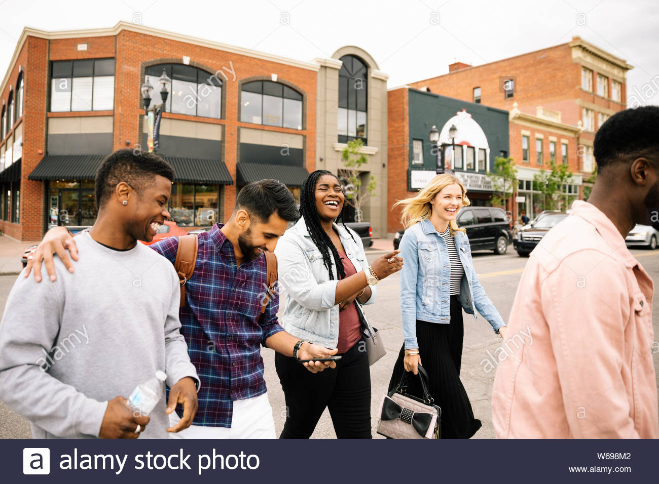 Happy friends crossing the street Stock Photo Alamy