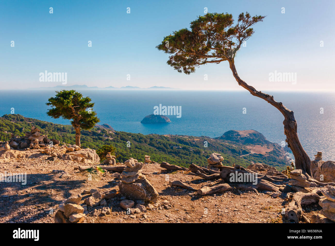 Sea skyview landscape photo from ruins of Monolithos castle on Rhodes island, Dodecanese, Greece. Panorama with green mountains and clear blue water. Stock Photo