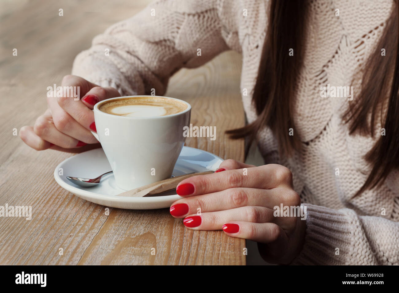 Artistic woman holding cup of coffee Stock Photo - Alamy