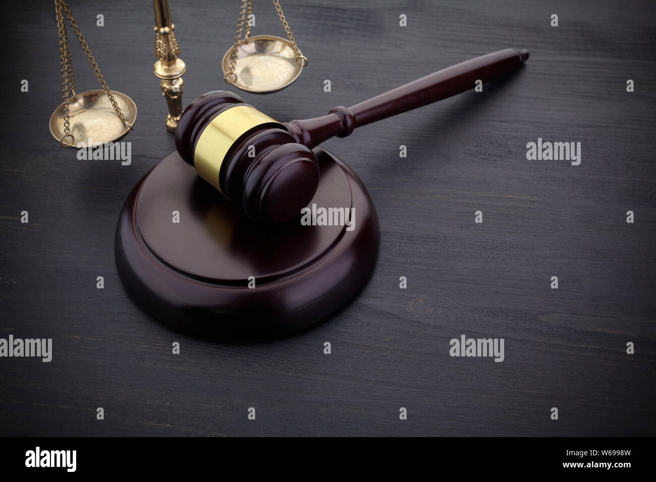 Judges Gavel And Scale Of Justice On The Black Table Background. Law Concept. Stock Photo