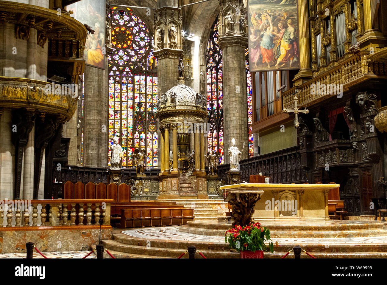 The altar with stained glass windows in the background. Duomo di Milano (Milan Cathedral). Stock Photo
